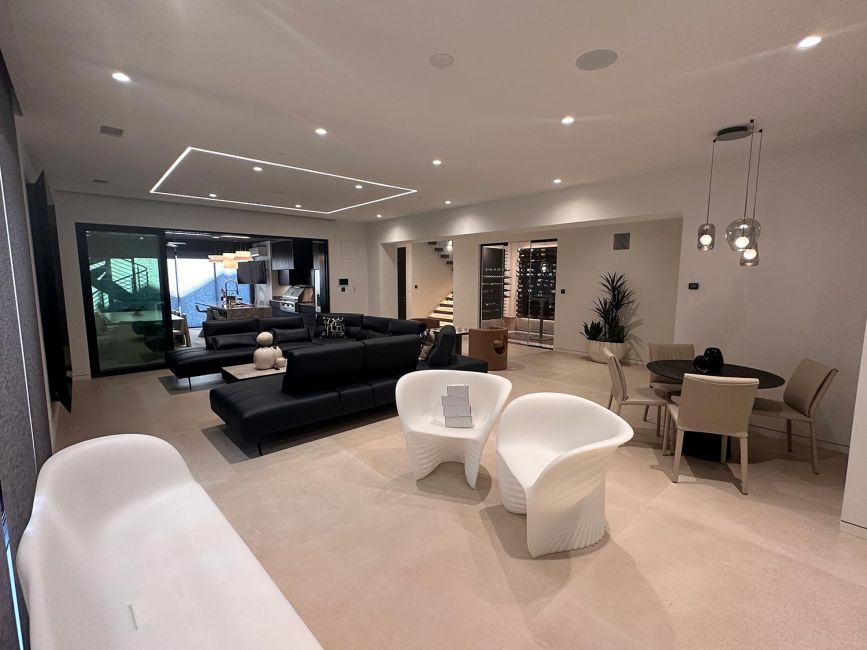Spacious modern home basement interior layout with sectionals and sculpted accent chairs