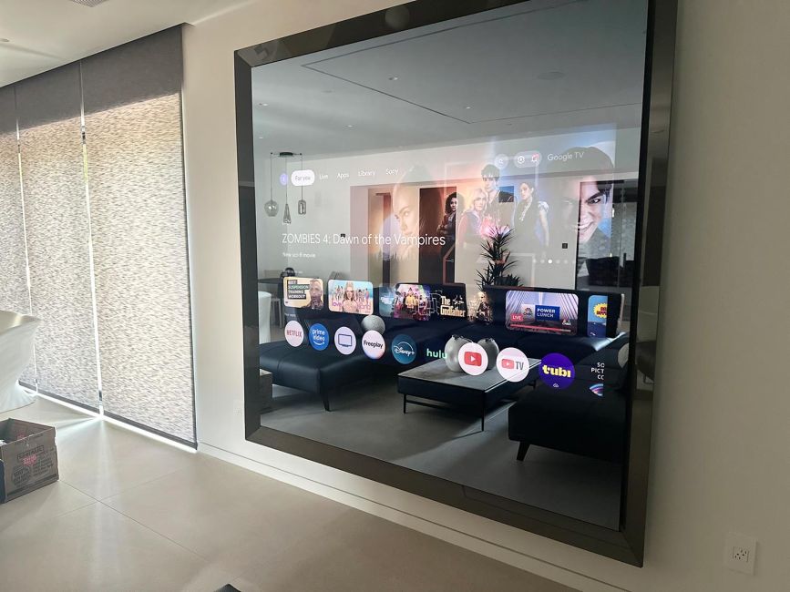 Smart television interface displayed on a large high-end mirror media screen