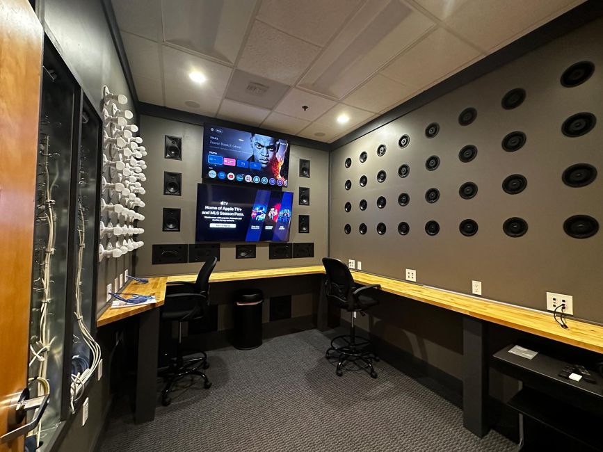 Sound testing control room with dual display screens, work counter, and circular acoustic wall array